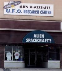 ['Earl, is that an alien spacecraft?' 'No, dear, it's a building.']